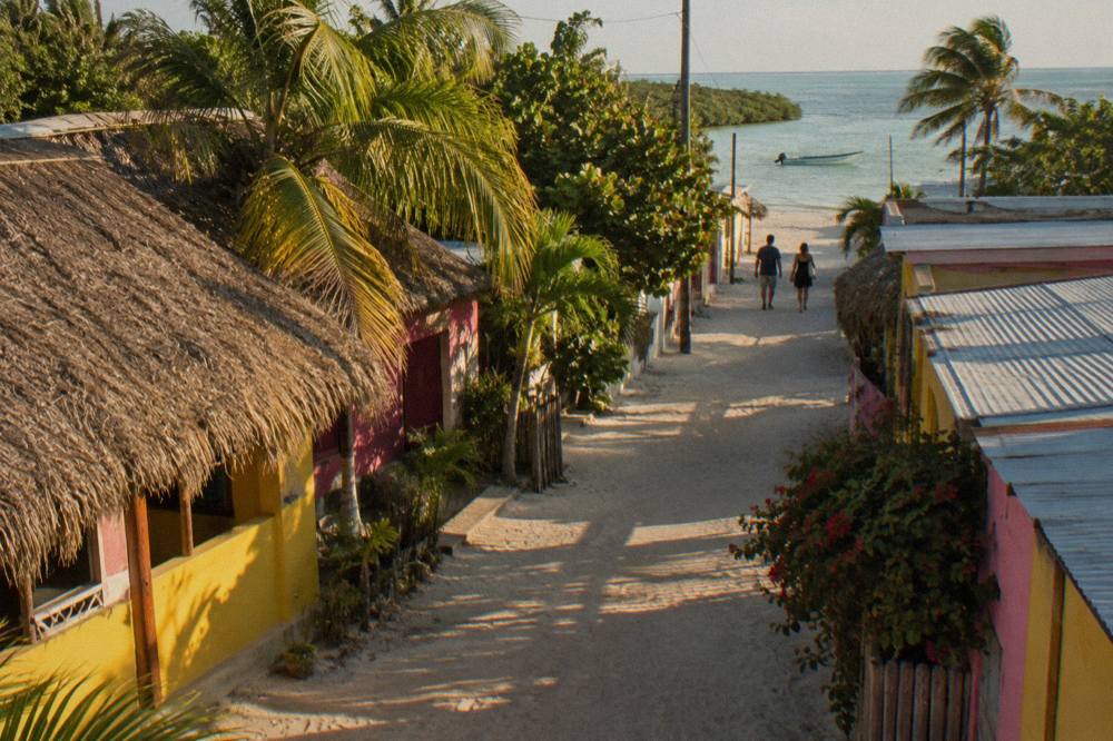 Quiet sandy lane on a small island with colourful painted walls and no cars