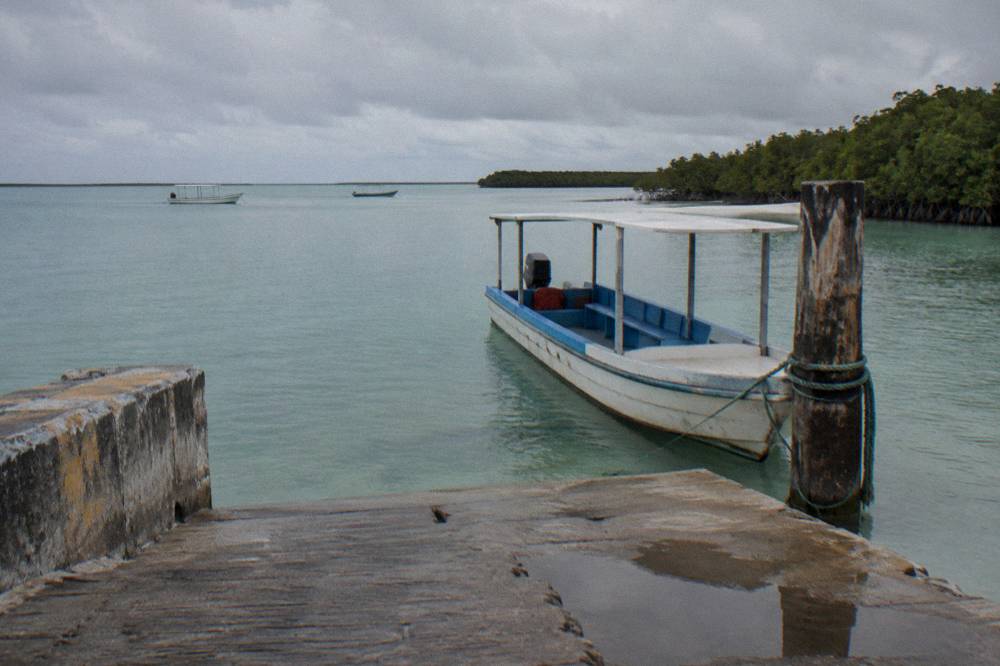 Small ferry dock and calm lagoon water at a mainland port town